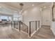 Inviting foyer features modern chandelier, wood floors, and staircase with metal railing at 5251 Silver Hare Ct, Castle Rock, CO 80104