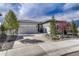 Charming home featuring a two-car garage, stone accents, and landscaped front yard at 5251 Silver Hare Ct, Castle Rock, CO 80104