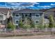 Rear view of a two-story home, complete with a well-maintained lawn, landscaping, and a white picket fence at 5251 Silver Hare Ct, Castle Rock, CO 80104