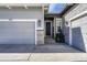 Close up of garage door, front door and stone column and front entry landscape at 5251 Silver Hare Ct, Castle Rock, CO 80104