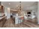 Open kitchen with a large island and seating, flowing to the living room at 5251 Silver Hare Ct, Castle Rock, CO 80104