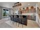Basement kitchenette with bar seating, stainless steel appliances, and stylish pendant lighting at 5251 Silver Hare Ct, Castle Rock, CO 80104