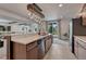 Modern kitchenette with stainless steel appliances, tile flooring and an island with bar seating at 5251 Silver Hare Ct, Castle Rock, CO 80104
