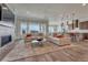 Open-concept living room with fireplace, large windows, and seamless flow to the kitchen at 5251 Silver Hare Ct, Castle Rock, CO 80104