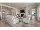 Cozy living room with a stone fireplace, views to the foyer and kitchen at 5251 Silver Hare Ct, Castle Rock, CO 80104