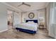 Main bedroom featuring wood floors, modern ceiling fan, sheer curtains, barn door, and large windows for lots of natural light at 5251 Silver Hare Ct, Castle Rock, CO 80104