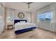 Bright main bedroom featuring wood floors, modern ceiling fan, sheer curtains, and large windows for lots of natural light at 5251 Silver Hare Ct, Castle Rock, CO 80104