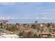 Aerial view of houses with mountains in the distance, highlighting the community's scenic location and neighborhood at 10055 Fort Worth Ct, Parker, CO 80134
