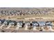 A birds-eye view of a suburban neighborhood featuring neat rows of houses, roads, and open spaces at 10055 Fort Worth Ct, Parker, CO 80134