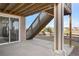 View of the backyard patio area, stairs, and partial view of the workout room through the sliding glass door at 10055 Fort Worth Ct, Parker, CO 80134