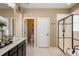 Bright bathroom featuring a walk-in shower and dark wood vanity at 10055 Fort Worth Ct, Parker, CO 80134