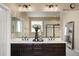 Beautifully updated bathroom features a jacuzzi tub, a separate shower, and a dual sink vanity with dark cabinets at 10055 Fort Worth Ct, Parker, CO 80134
