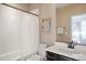 Bright bathroom featuring a shower with tub and vanity with white countertop at 10055 Fort Worth Ct, Parker, CO 80134