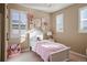 Charming bedroom featuring natural light, a decorative chandelier, and flower wall decor at 10055 Fort Worth Ct, Parker, CO 80134