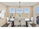 Dining room with a view of the landscape and a stylish chandelier at 10055 Fort Worth Ct, Parker, CO 80134