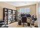 Spacious home office featuring large bookshelves, a work desk, and natural light at 10055 Fort Worth Ct, Parker, CO 80134
