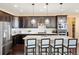 Modern kitchen featuring stainless steel appliances, dark cabinetry, and a large center island at 10055 Fort Worth Ct, Parker, CO 80134
