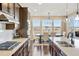 Modern kitchen featuring stainless steel appliances, dark cabinetry, and a adjacent dining area at 10055 Fort Worth Ct, Parker, CO 80134