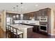 Modern kitchen featuring stainless steel appliances, dark cabinetry, and a large center island at 10055 Fort Worth Ct, Parker, CO 80134