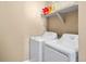 Laundry room featuring a set of white washer and dryer units and storage shelves at 10055 Fort Worth Ct, Parker, CO 80134