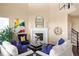 Cozy living room with a fireplace, comfortable seating, and bright colorful artwork at 10055 Fort Worth Ct, Parker, CO 80134