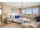 The main bedroom features a luxurious bed, mirrored nightstands, and scenic views, creating a serene retreat at 10055 Fort Worth Ct, Parker, CO 80134
