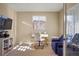Bright office featuring a sleek white desk, cozy seating, and ample natural light, perfect for a productive workspace at 10055 Fort Worth Ct, Parker, CO 80134