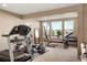 Spacious workout room featuring large windows offering natural light and views, and a variety of exercise equipment at 10055 Fort Worth Ct, Parker, CO 80134