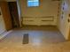 Unfinished basement with peeling walls, small window, and worn floor, awaiting your personal touch at 3054 Victor St, Aurora, CO 80011
