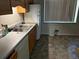 Kitchen featuring double basin sink, dishwasher, wood cabinets, and tile flooring at 3054 Victor St, Aurora, CO 80011