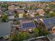 Stunning aerial view showcases a neighborhood with solar panels and well manicured yards and hot tubs at 5471 Ensenada Ct, Denver, CO 80249