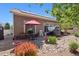 Relaxing backyard patio features a hot tub, dining area, and colorful landscaping at 5471 Ensenada Ct, Denver, CO 80249