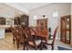 Formal dining room features a large wood table, wood floors, and a built-in display case at 5471 Ensenada Ct, Denver, CO 80249