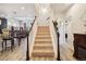 Bright entryway features a carpeted staircase, and access to the living room and hallways at 5471 Ensenada Ct, Denver, CO 80249