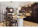 Spacious kitchen featuring granite island, dark cabinets, and stainless steel appliances at 5471 Ensenada Ct, Denver, CO 80249