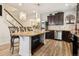 Elegant kitchen with granite island, dark wood cabinets, and stainless steel appliances at 5471 Ensenada Ct, Denver, CO 80249