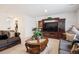Comfortable living room with a large TV, two sofas, and a decorative glass table at 5471 Ensenada Ct, Denver, CO 80249