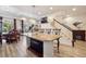 Open-concept living area with dining space and staircase access to the second floor at 5471 Ensenada Ct, Denver, CO 80249