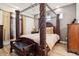Spacious main bedroom featuring a four-post bed frame, hard wood floors, and neutral decor at 5471 Ensenada Ct, Denver, CO 80249