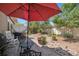 Outdoor patio featuring a cozy seating area and manicured landscaping with rocks at 5471 Ensenada Ct, Denver, CO 80249