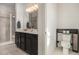 Bright bathroom featuring a double sink vanity, toilet, and glass enclosed shower at 14700 E 104Th Ave # 1105, Commerce City, CO 80022