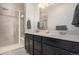 Well-lit bathroom with double vanity sinks and modern shower with glass enclosure at 14700 E 104Th Ave # 1105, Commerce City, CO 80022