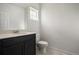 Cozy half bath featuring a modern vanity, mirror, and toilet at 14700 E 104Th Ave # 1105, Commerce City, CO 80022