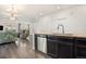 Stylish kitchen featuring granite countertops and stainless steel dishwasher adjacent to an open living area at 14700 E 104Th Ave # 1105, Commerce City, CO 80022
