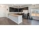 Modern kitchen with dark cabinetry, granite counters, and stainless steel appliances and breakfast bar at 14700 E 104Th Ave # 1105, Commerce City, CO 80022