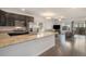 Open-concept kitchen featuring granite countertops and stainless steel appliances flowing into the living area at 14700 E 104Th Ave # 1105, Commerce City, CO 80022