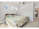 Comfortable bedroom with a ceiling fan, three sunny windows and plush carpeting at 14700 E 104Th Ave # 1105, Commerce City, CO 80022