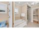 This bathroom features a soaking tub with marble surround and a glass enclosed shower with a walk in closet at 1824 Pearl St # B, Boulder, CO 80302