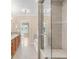 This bathroom offers double sinks with wood cabinets and granite counters and a glass shower with a seat at 1824 Pearl St # B, Boulder, CO 80302