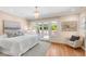 Bedroom with hardwood floors, French doors to patio, and modern chandelier at 1824 Pearl St # B, Boulder, CO 80302